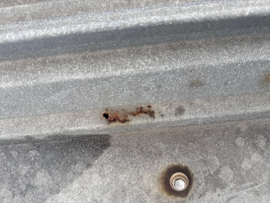 Project photo: Commercial Metal Roof Fastener Sealing and Gutter Outlet Clearing – Charlotte, NC