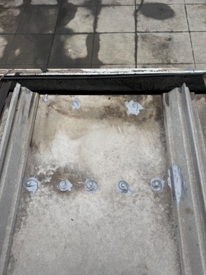 Commercial Metal Roof Fastener Sealing and Gutter Outlet Clearing – Charlotte, NC project photo 4